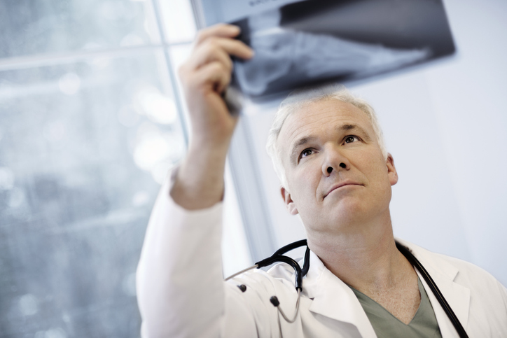 Male Doctor Examining An X-Ray Image