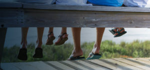 Family sitting on bench by the sea