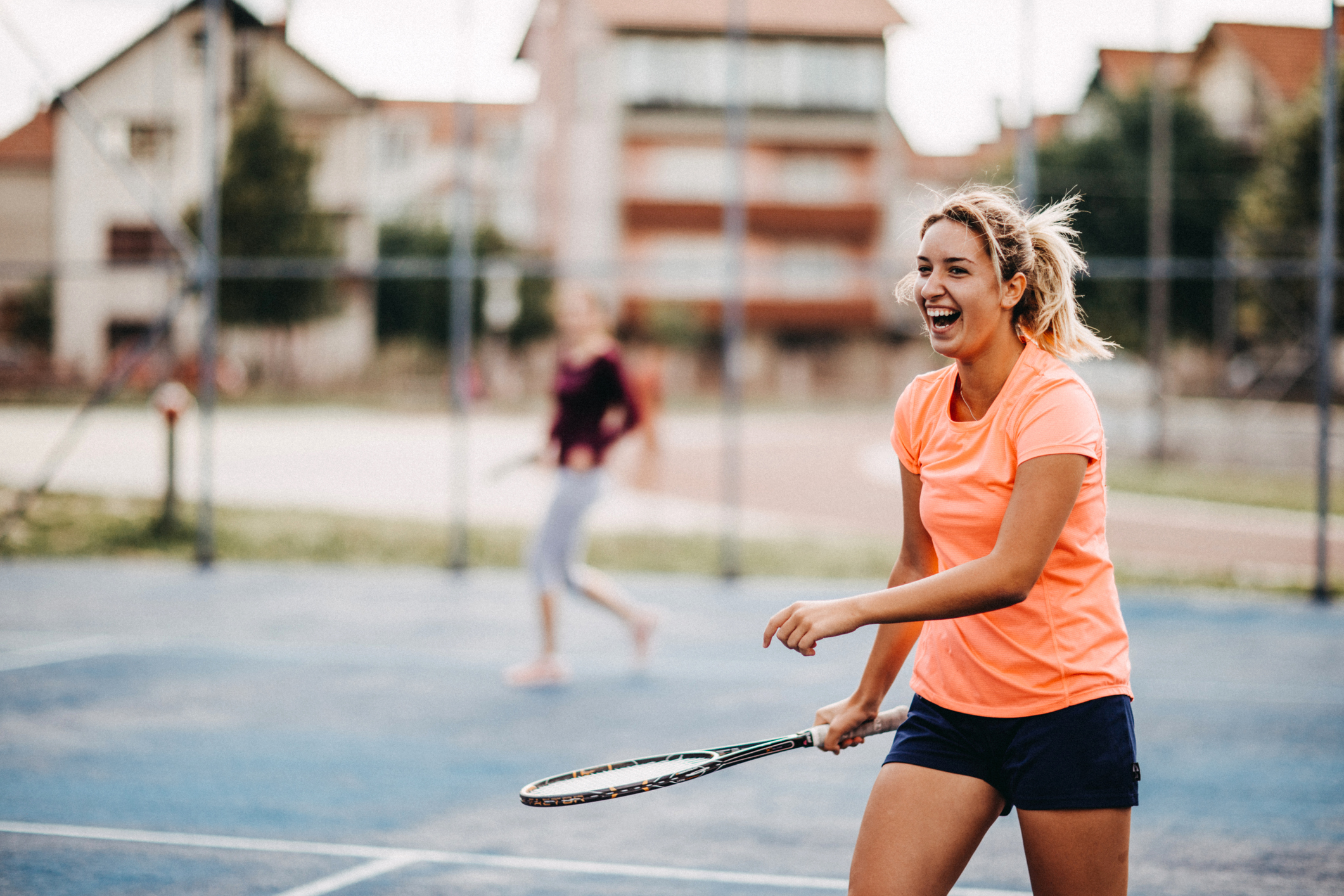 Happy young girls playing tennis Female Tennis Player