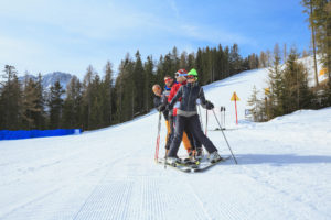 Friends skiing on slopes