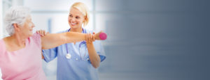 Nurse helping elderly woman with Physical Therapy