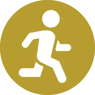 White silhouette of a person running inside a gold circle, used as a safety/exit icon.